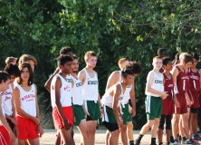 Varsity Boys prime themselves at the starting line. Photo by Alex Ng.