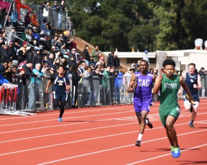 Cummings (12) keeps ahead of Sacramento High opponent in the sprint relay at Clarke Massey Relays, Feb 24.   Clarion photo by Sarif Morningstar